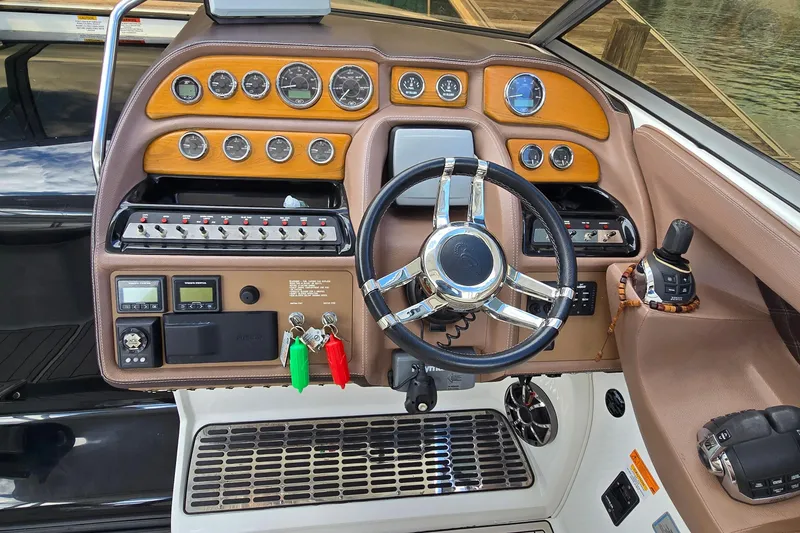 Slide: The Image of Dashboard of a 2011 Cobalt 323 boat with steering wheel and control panel. - 15