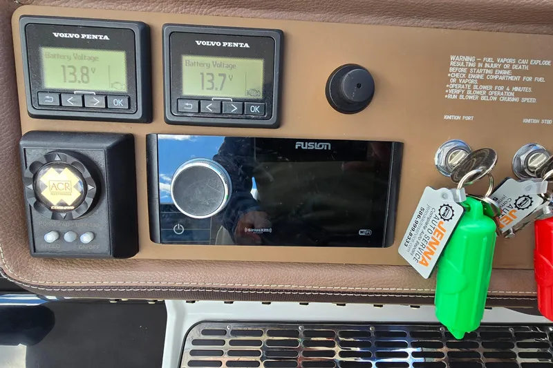Slide: The Image of Control panel of a 2011 Cobalt 323 boat with battery voltage displays and ignition keys. - 16