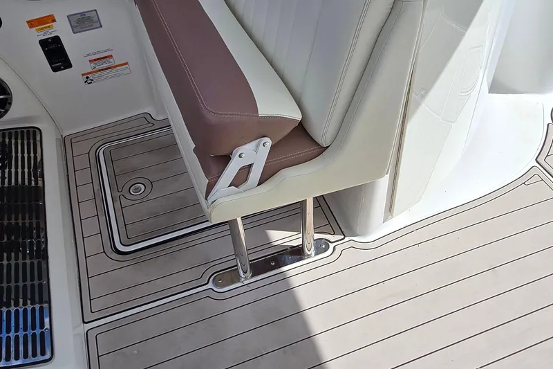 Slide: The Image of 2011 Cobalt 323 boat interior with brown and white seating and teak-style flooring. - 20