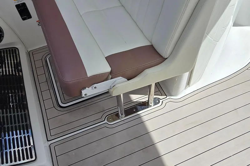 Slide: The Image of 2011 Cobalt 323 boat interior with cushioned seating and sleek flooring design. - 21