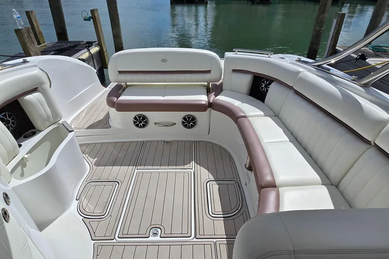 Slide: The Image of Luxurious 2011 Cobalt 323 boat interior with white leather seating and wood flooring. - 24
