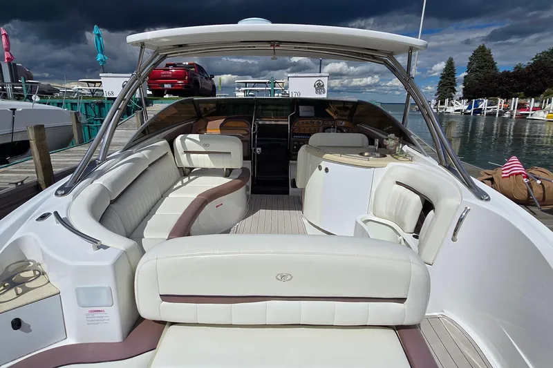 Slide: The Image of Luxurious 2011 Cobalt 323 boat with spacious seating, docked by a scenic marina. - 25