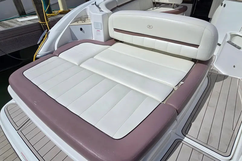 Slide: The Image of 2011 Cobalt 323 boat with white and brown cushioned seating on deck. - 26