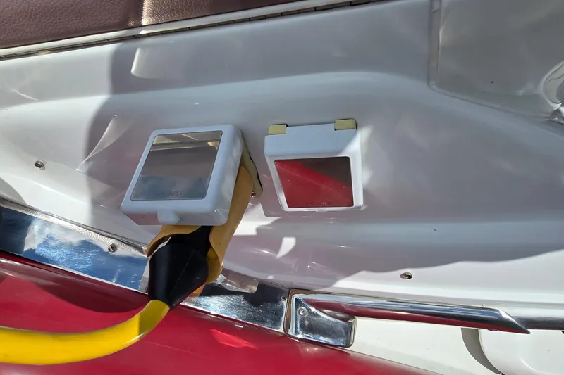 Slide: The Image of Power outlet on a 2011 Cobalt 323 boat with yellow cable connected. - 27