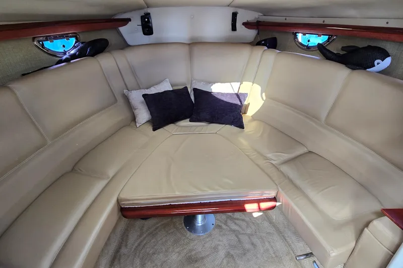 Slide: The Image of Luxurious interior of 2011 Cobalt 323 boat with beige seating and decorative pillows. - 32