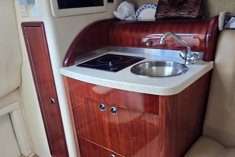 Slide: The Image of Compact kitchenette in 2011 Cobalt 323 boat with sink and stove. - 33