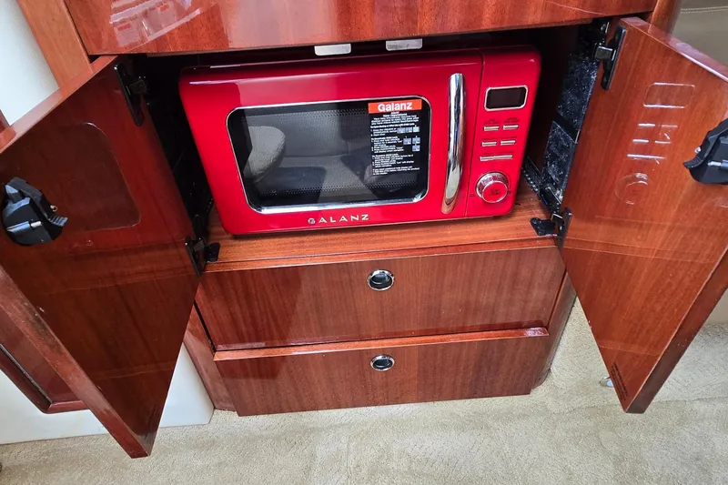 Slide: The Image of Red Galanz microwave inside wooden cabinet of 2011 Cobalt 323 boat. - 37