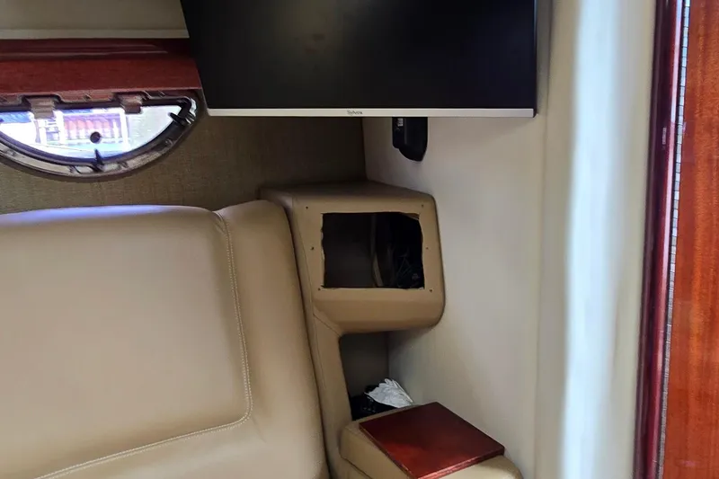 Slide: The Image of Interior of a 2011 Cobalt 323 boat with beige seating and a mounted TV. - 38
