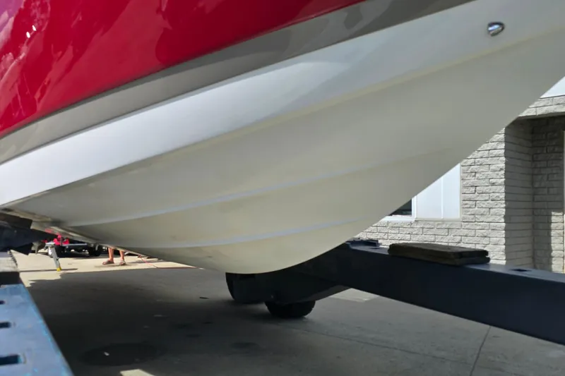 Slide: The Image of 2011 Cobalt 323 boat hull on trailer, red and white exterior. - 4