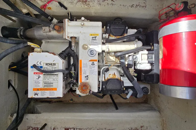 Slide: The Image of Engine compartment of a 2011 Cobalt 323 boat with Kohler generator and fire extinguisher. - 41