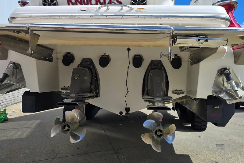 Slide: The Image of Rear view of a 2011 Cobalt 323 boat with dual propellers and outboard motors. - 7