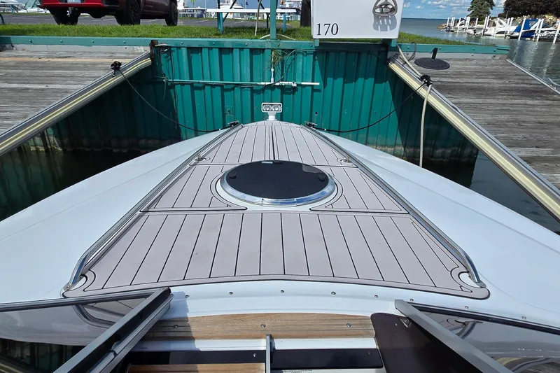 Slide: The Image of 2011 Cobalt 323 boat docked, featuring sleek deck design and marina backdrop. - 8