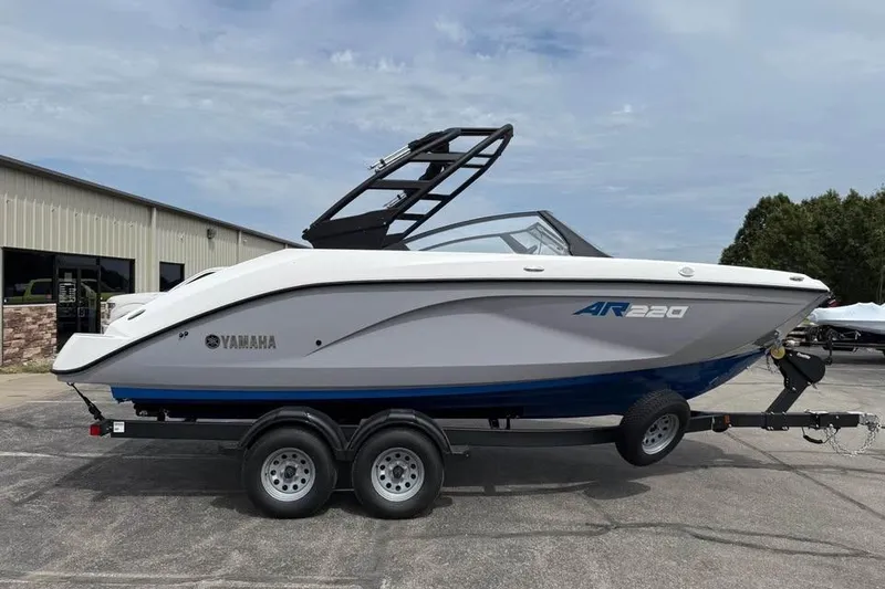 The Image of 2026 Yamaha Boats AR220 on trailer, sleek design, parked outdoors. - 0