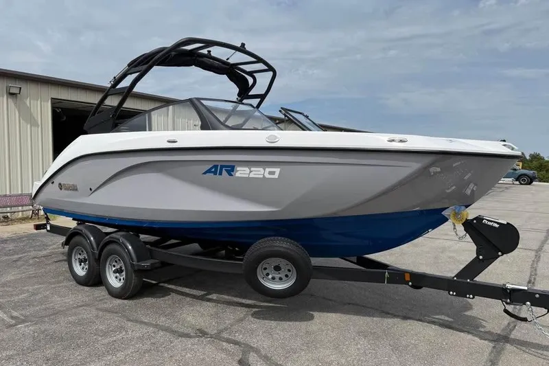 Slide: The Image of 2026 Yamaha Boats AR220 on trailer, parked outside a building. - 1