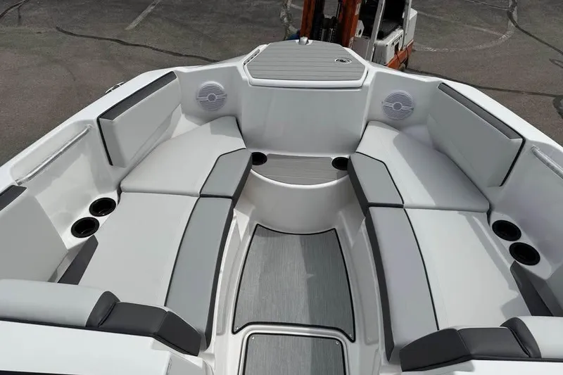 Slide: The Image of 2026 Yamaha Boats AR220 interior with spacious seating and cup holders. - 12