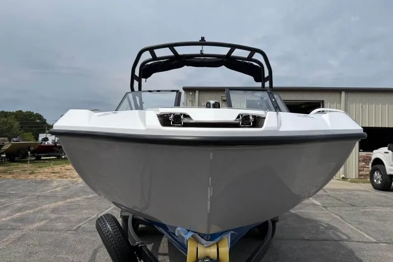 Slide: The Image of 2026 Yamaha Boats AR220, sleek design, parked outdoors on a trailer. - 2