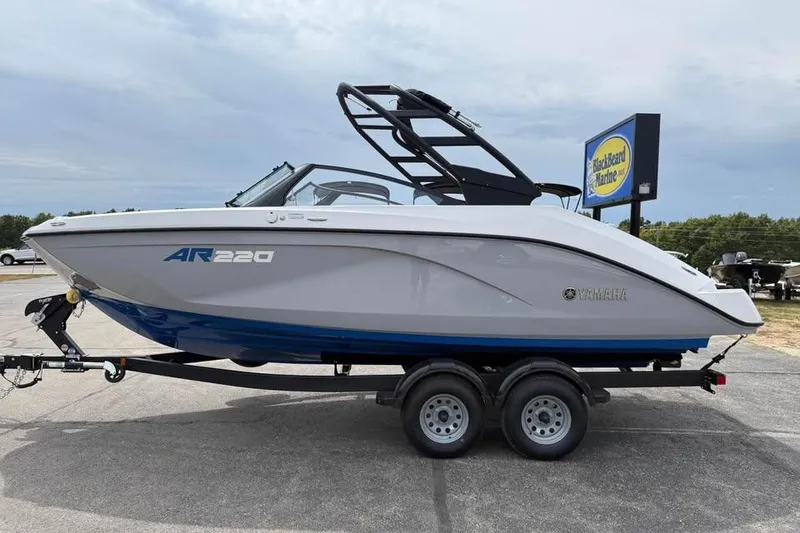 Slide: The Image of 2026 Yamaha Boats AR220 on trailer, sleek design, parked outdoors. - 4