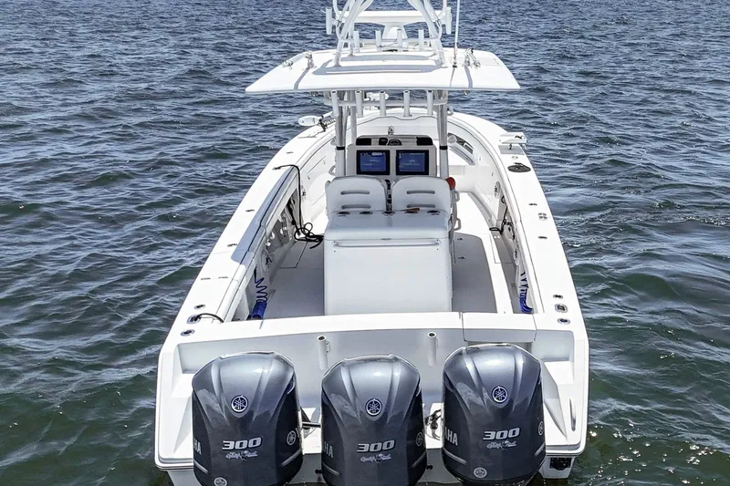 Slide: The Image of 2017 Jupiter 34 FS boat with triple Yamaha 300 engines on open water. - 4