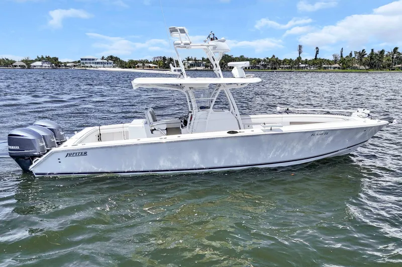Slide: The Image of 2017 Jupiter 34 FS boat on water with twin Yamaha engines, clear sky background. - 9