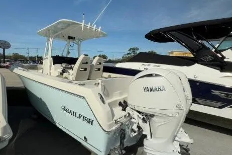 Slide: The Image of 2024 Sailfish 242 CC boat with Yamaha engine, docked outdoors under clear sky. - 17