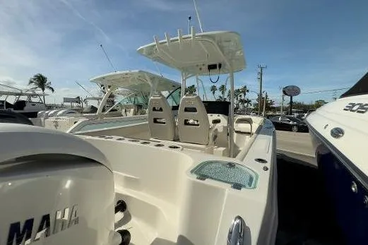 Slide: The Image of 2024 Sailfish 242 CC boat with Yamaha engine, docked under clear blue sky. - 19