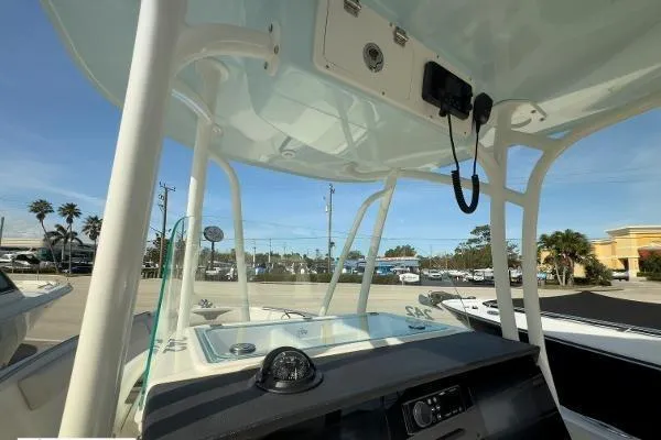 Slide: The Image of 2024 Sailfish 242 CC boat console with T-top and navigation equipment. - 3