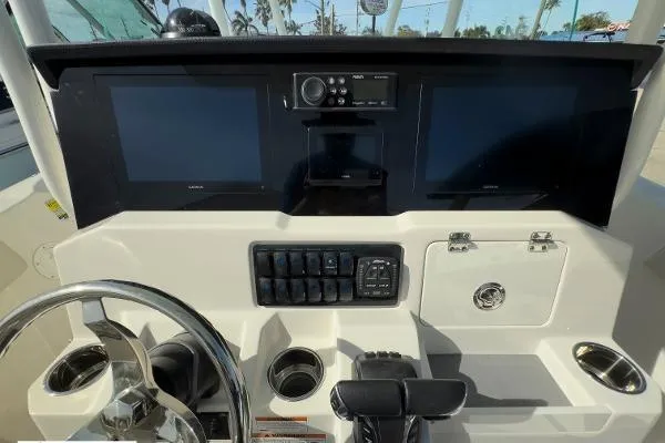 Slide: The Image of 2024 Sailfish 242 CC boat dashboard with dual screens and control panel. - 5