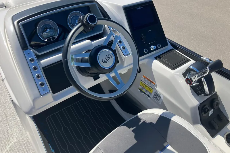 Slide: The Image of 2023 Barletta CORSA 25UE boat dashboard with steering wheel and control panel. - 10
