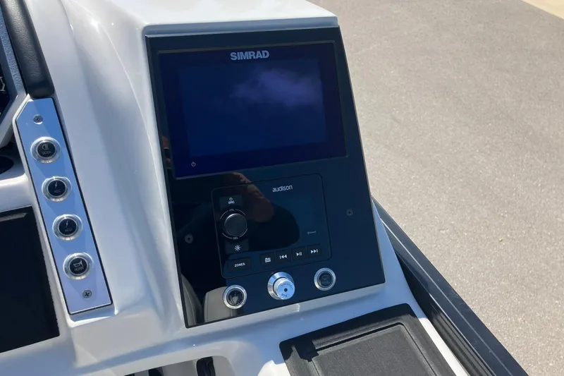 Slide: The Image of 2023 Barletta CORSA 25UE dashboard with Simrad display and audio controls. - 12