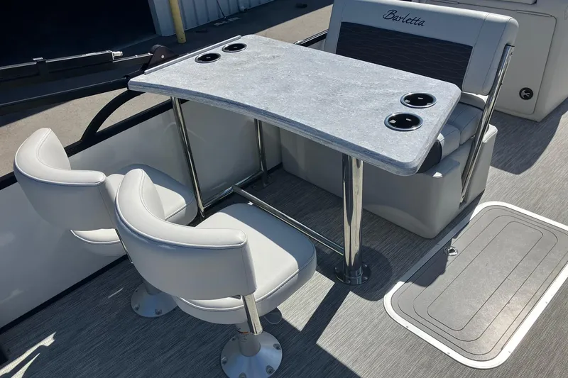 Slide: The Image of 2023 Barletta CORSA 25UE boat interior with table and seating arrangement. - 14
