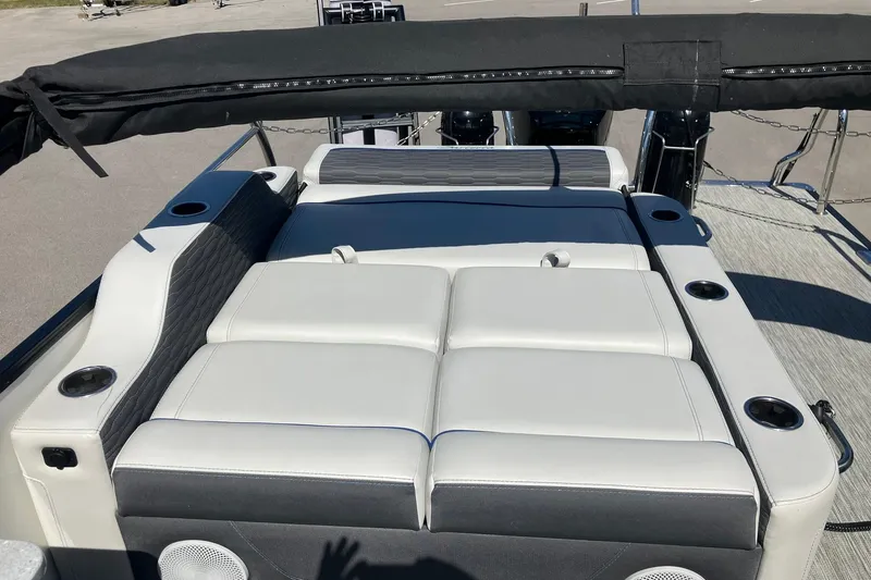 Slide: The Image of 2023 Barletta CORSA 25UE boat interior with cushioned seating and cup holders. - 15