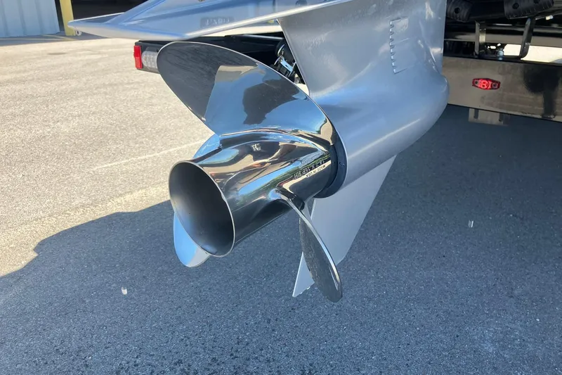 Slide: The Image of 2023 Barletta CORSA 25UE boat propeller, shiny metal finish, parked on asphalt. - 21