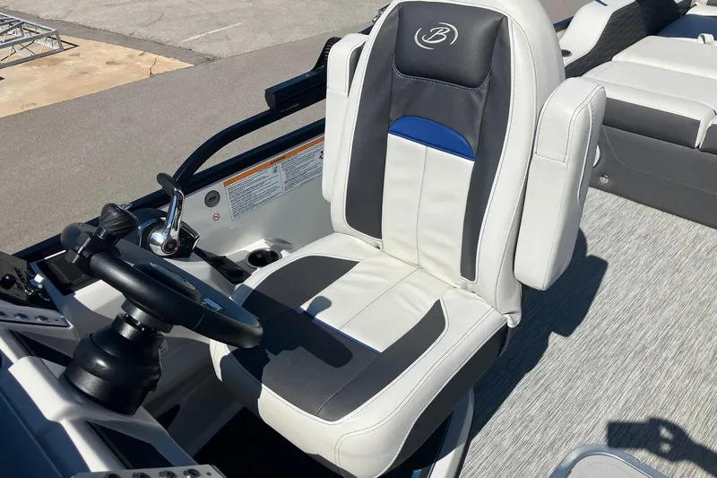 Slide: The Image of Captain's seat of 2023 Barletta CORSA 25UE boat, featuring sleek design and controls. - 9