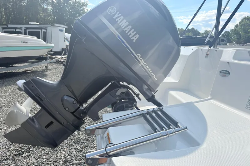 Slide: The Image of 2024 Hurricane SS boat with Yamaha outboard motor, parked on gravel lot. - 10