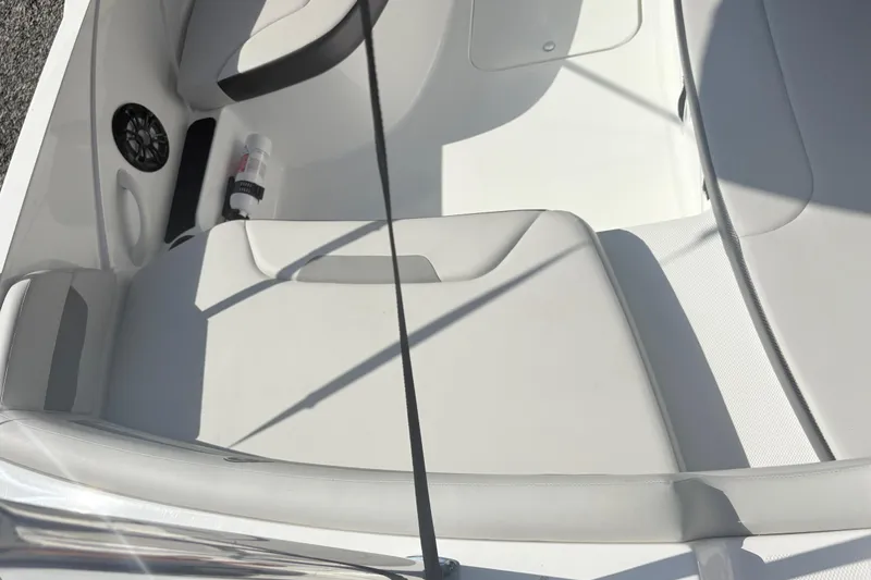 Slide: The Image of 2024 Hurricane SS boat interior with white seating and speaker. - 14