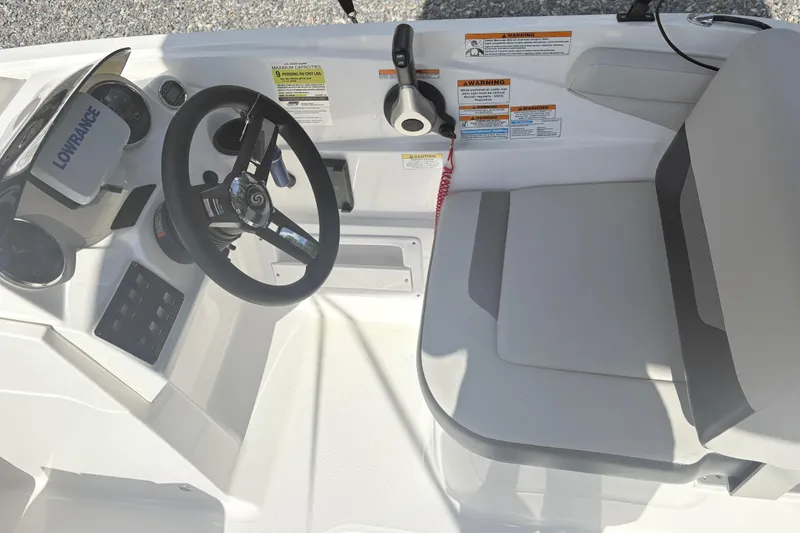 Slide: The Image of 2024 Hurricane SS boat cockpit with steering wheel, seat, and control panel. - 16