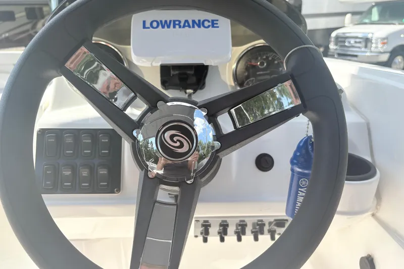 Slide: The Image of Steering wheel of 2024 Hurricane SS boat with Lowrance display and Yamaha keychain. - 17