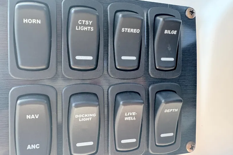 Slide: The Image of Control panel with switches for horn, lights, stereo, and more on 2024 Hurricane SS. - 18