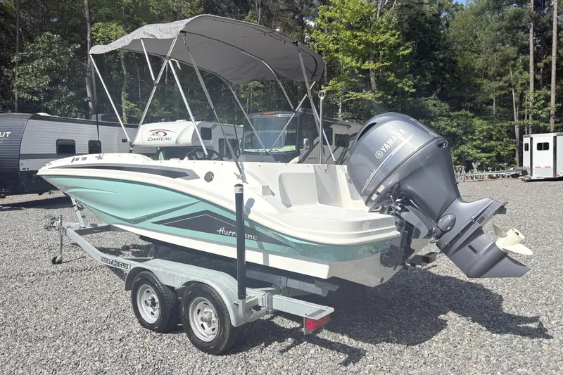 Slide: The Image of 2024 Hurricane SS boat on trailer with Yamaha outboard motor in outdoor setting. - 2