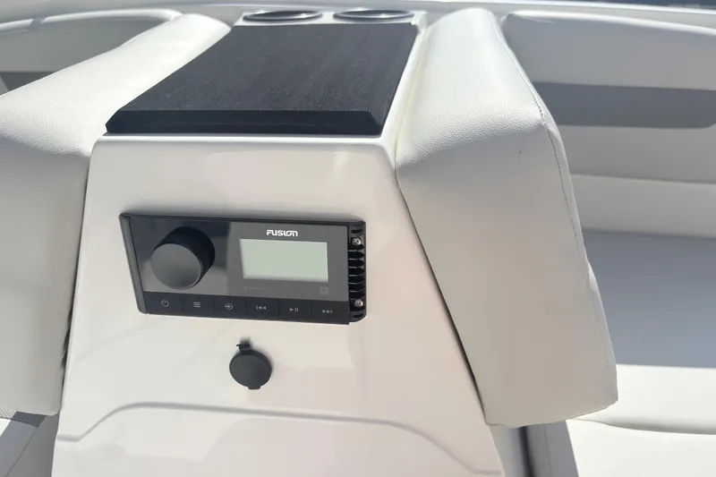 Slide: The Image of 2024 Hurricane SS boat interior with Fusion audio system and cup holders. - 22