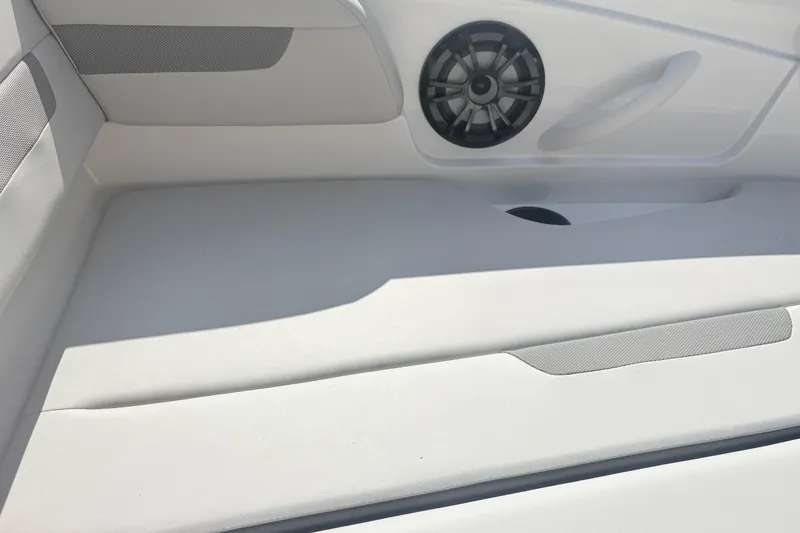 Slide: The Image of 2024 Hurricane SS boat interior with speaker and white seating. - 23