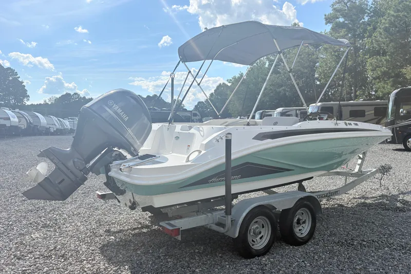 Slide: The Image of 2024 Hurricane SS boat with Yamaha engine on trailer, parked outdoors. - 4