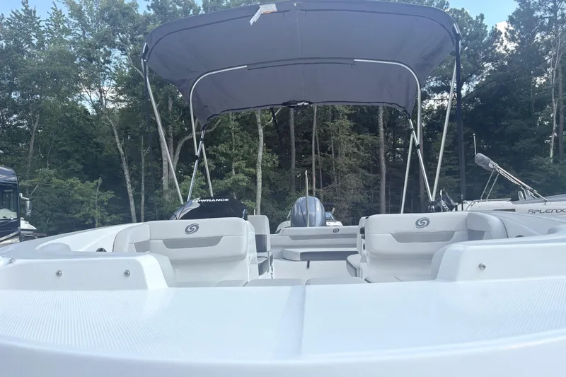 Slide: The Image of 2024 Hurricane SS boat with canopy, parked in a wooded area. - 7