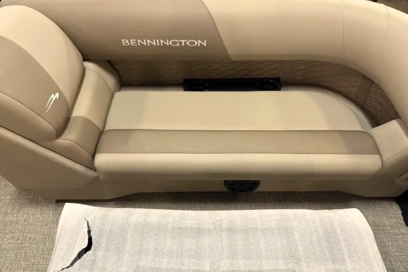 Slide: The Image of 2026 Bennington 22 SSRSE pontoon boat with black cover in a warehouse setting. - 11