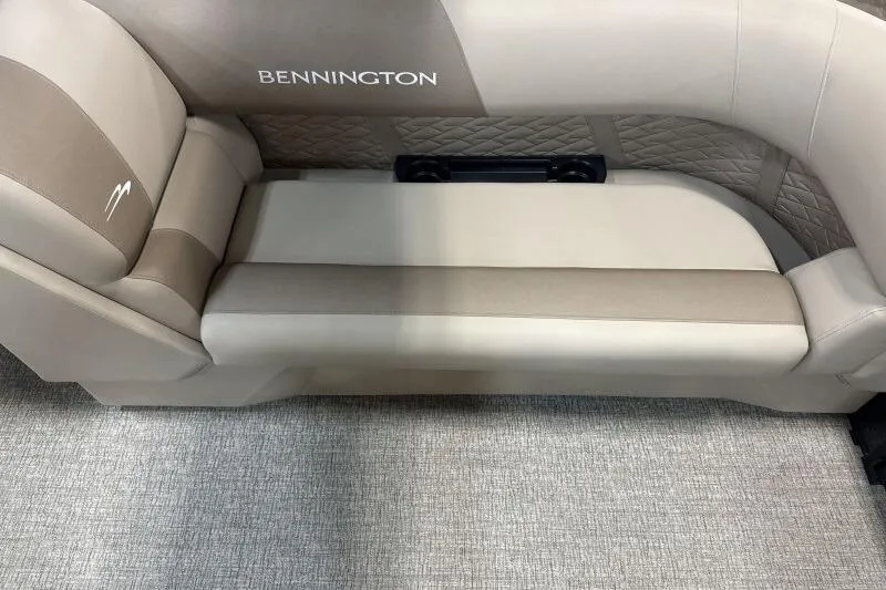 Slide: The Image of 2026 Bennington 22 SSRSE boat interior seating with beige upholstery and quilted design. - 20