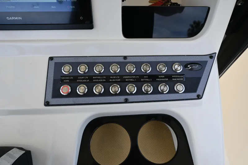 Slide: The Image of Control panel of 2021 Scout 255 LXF boat with labeled switches and Garmin display. - 13