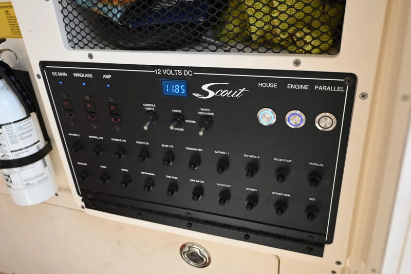 Slide: The Image of Control panel of a 2021 Scout 255 LXF boat with various switches and indicators. - 14