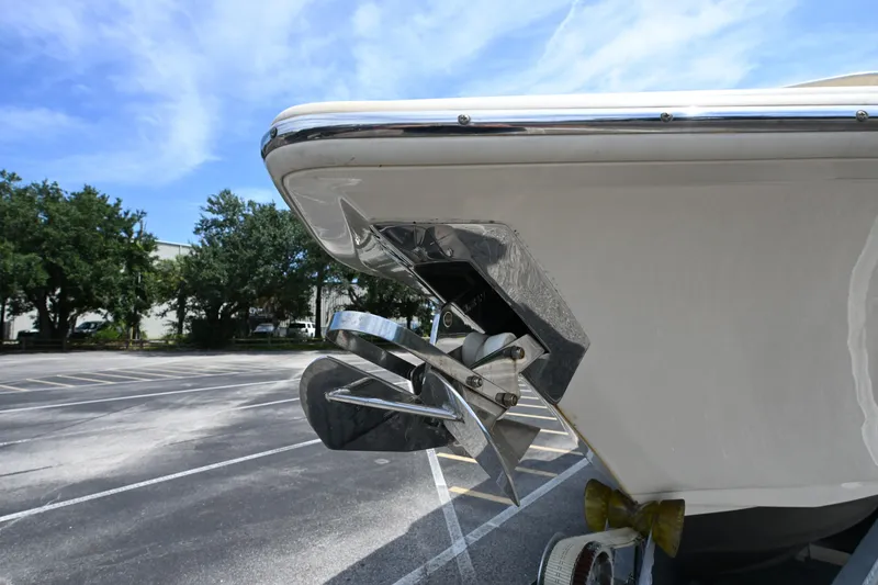 Slide: The Image of 2021 Scout 255 LXF boat anchor detail in parking lot under blue sky. - 18