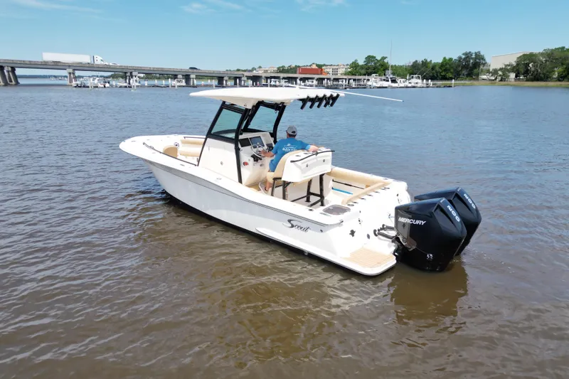 Slide: The Image of 2021 Scout 255 LXF boat with dual Mercury engines on a calm river. - 20