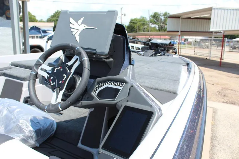 Slide: The Image of 2026 Skeeter FXR20 FLEX boat interior with steering wheel and dashboard display. - 12